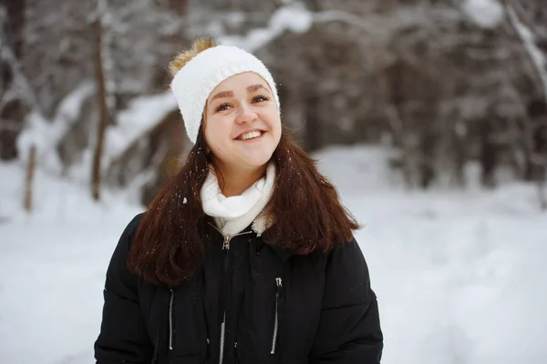 Mladá, hezká, veselá dlouhosrstá žena v zasněženém lese. — Stock fotografie