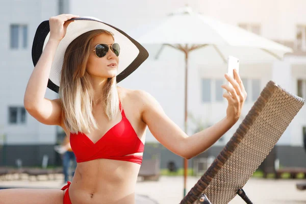Young pretty woman in a red swimsuit — Stock Photo, Image