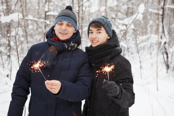 Szczęśliwy mężczyzna i nastolatek chłopiec w śnieżnym lesie zimowym. — Zdjęcie stockowe