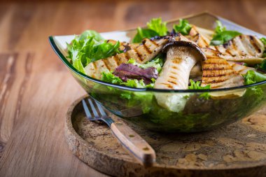 Green vegetable salad with grilled king oyster mushrooms clipart