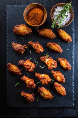 Sıcak ve baharatlı tavuk kanadı ile baharat koyu arka plan üzerinde 