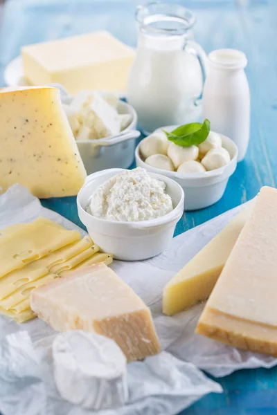 Different types of dairy products on wooden background — Stock Photo, Image