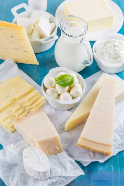 Different types of dairy products on wooden background — Stock Photo, Image