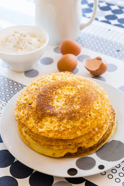 Stack of pancakes with baking ingredients — Stock Photo, Image