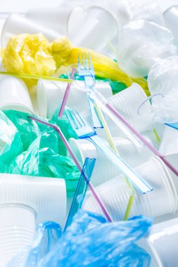 Tek kullanımlık plastik, bardak, çatal bıçak, torba ve pipet çeşitleri. Çevresel konsept. Gübrelenmeyen atık