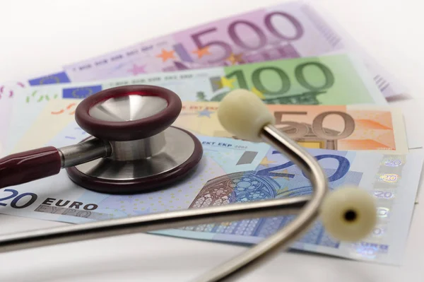 Medical stethoscope and banknotes of Euro currency — Stockfoto