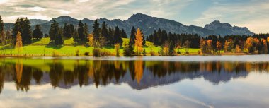 panoramic view to beautiful lake with reflection in Bavaria, Germany clipart