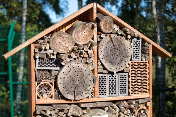 wooden hand made bug hotel for insects, bees and butterflies