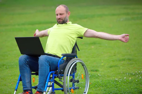 Adam tekerlekli sandalye kol germe üzerinde — Stok fotoğraf