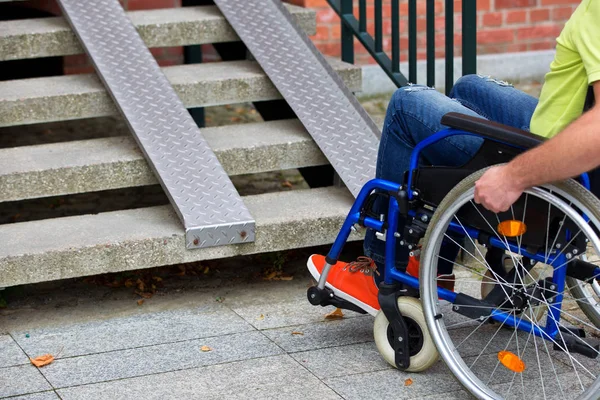 Man on wheelchair trying to go up the stairs — Stock Photo, Image