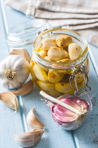Marinated garlic. Pickled garlic in jar on kitchen table. — Stock Image Marinated Garlic Pickled Garlic Jar Kitchen Table Royalty Free Stock Images