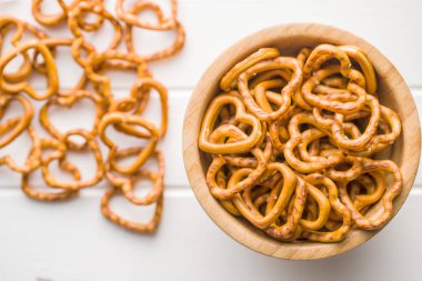 Heart shaped pretzel on white table. clipart