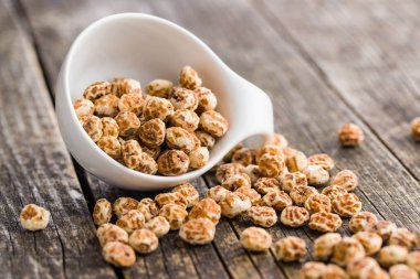 Tiger nuts. Tasty chufa nuts. Healthy superfood on old wooden table. clipart