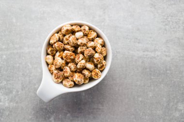 Tiger nuts. Tasty chufa nuts. Healthy superfood in bowl. clipart