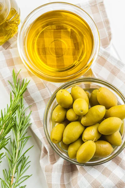 Groene olijven en olijfolie in glazen schaal. — Stockfoto