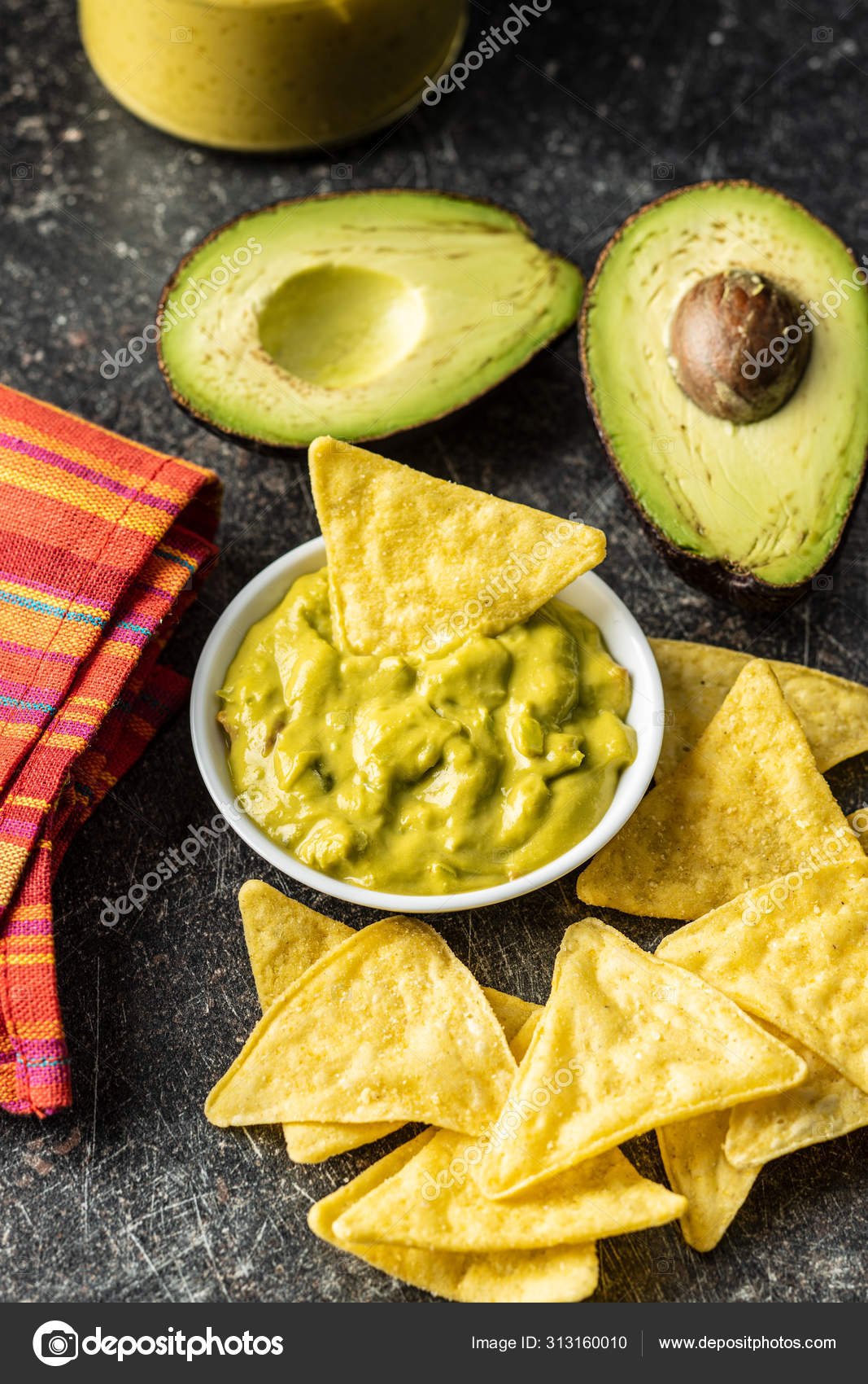 Corn nacho chips and avocado dip. Yellow tortilla chips and guac Stock