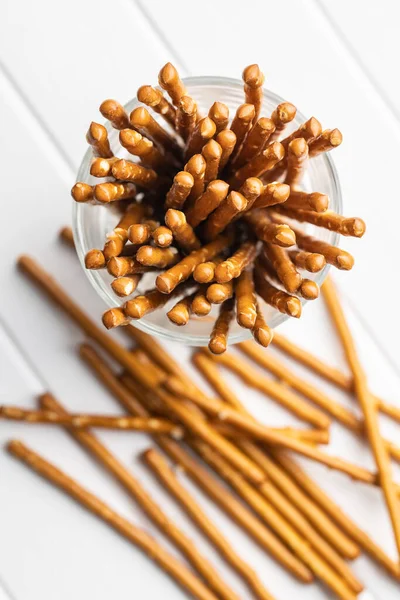 Salty sticks. Crunchy pretzels in glass. Top view.