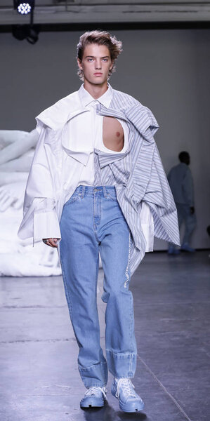 New York, NY, USA - July 10, 2018: A model walks runway for Feng Chen Wang Spring/Summer 2019 runway show during NY Fashion Wweek: Mens at Industria Studios, Manhattan