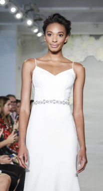 NEW YORK, USA - October 4, 2018: A model walks the runway at the Theia runway show during New York Bridal Week at the Theia Showroom, Manhattan clipart