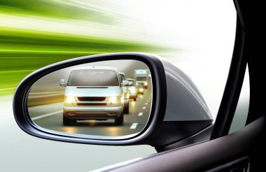 reflection of traffic flow in left side rear view mirror at twilight time clipart