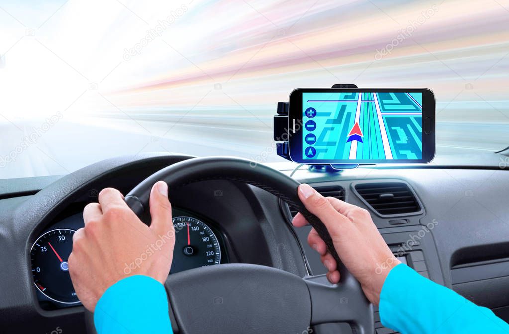 navigator on dashboard and hands of driver that sits on driver's seat