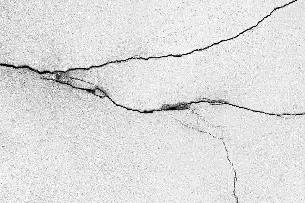 Cracks on the wall - detail of the cracked plaster - grunge texture