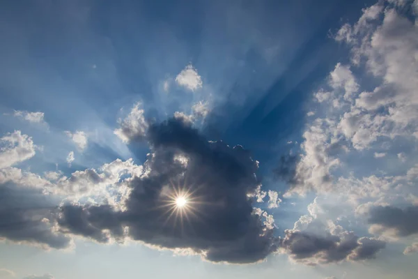 Sun behind the cloud with a hole — Stock Photo, Image
