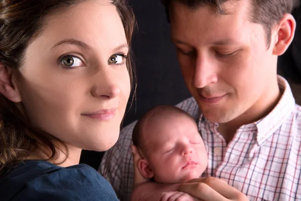 Proud New Mother Foreground Smiles Camera Whilst Father Holds Newborn — Stock Photo, Image