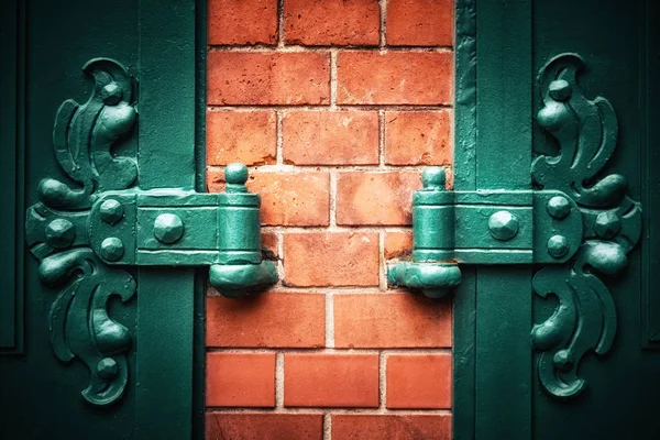 Symmetrical Ornate Metal Hinges Red Brick Wall Vignette Traditional Style — Stock Photo, Image