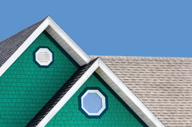 Detail of the typical style of colourful houses in Iles de la Madeleine, or the Magdalen Islands, Canada. Minimalistic style in blue, white and green with space for text.  clipart