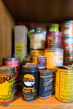 Quebec Province, Canada - 25th January 2015: A stack of old product tins for sale in a flea market, including motor products, paints, household repairs and cleaning agents clipart