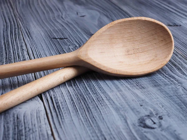 Wooden spoon on the wooden background