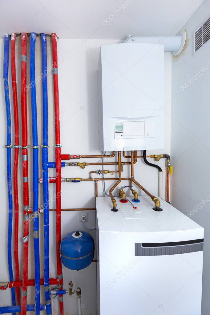 Pipes and boiler of gas heating system in the house