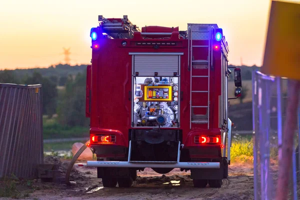 Flashing lights of red fire truck at dusk