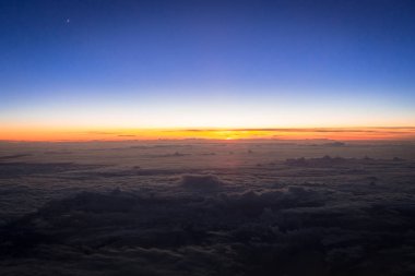 Günbatımı bulutların üzerinde hava toplayan