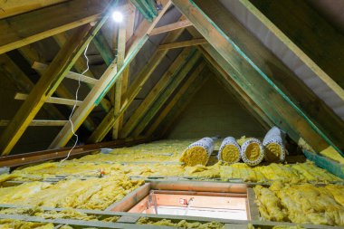 Empty attic in the house with mineral wool insulation clipart