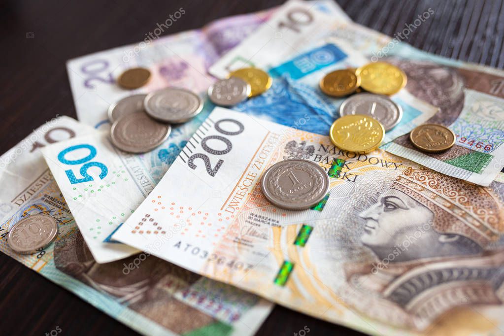 Stack of polish zloty banknotes and coins