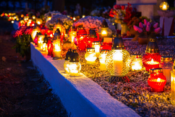 Colorful candles on the cemetery at All Saints Day, Poland