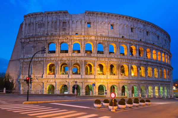 The Colosseum illuminated at dawn in Rome, Italy