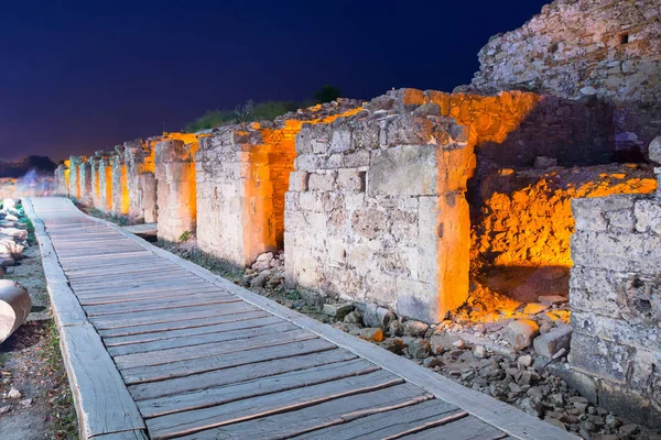 Ruins of ancient houses in Side town at night, Turkey