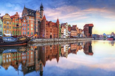 Gdansk with old town and port crane reflected in Motlawa river at sunrise, Poland. clipart