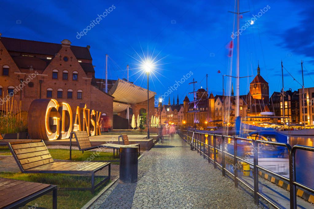 Beautiful architecture of Gdansk with an outdoor sign at dusk, Poland