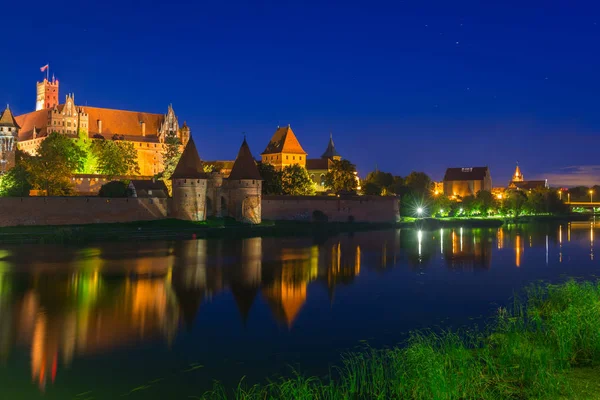 Castello di Malbork sul fiume Nogat di notte, Polonia — Foto Stock