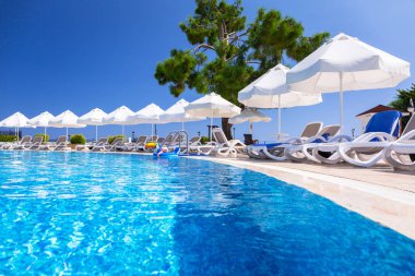 Tekirova, Turkey - September 7, 2019: Beautiful pool area of the Phaselis Rose hotel in Tekirova, Turkey. Tekirova is a seaside resort and of Antalya Province on the Mediterranean coast of Turkey clipart