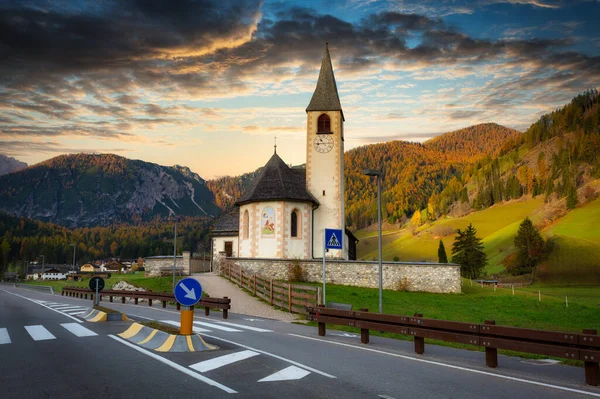 Idyllic scenery of the small church in Alps mountains at sunrise, Italy