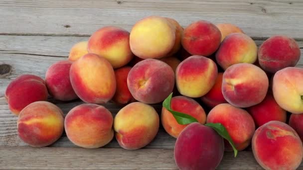 桃の山 茶色の木製の背景に熟した桃の果実 — ストック動画