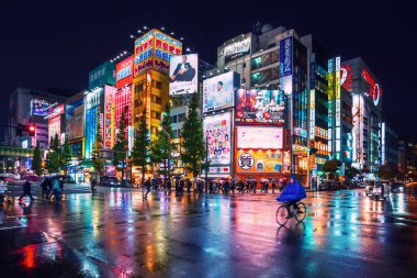 Yağmurlu bir gecede Akihabara, Tokyo ve Japonya 'daki binaların neon ışıkları ve reklam panoları.