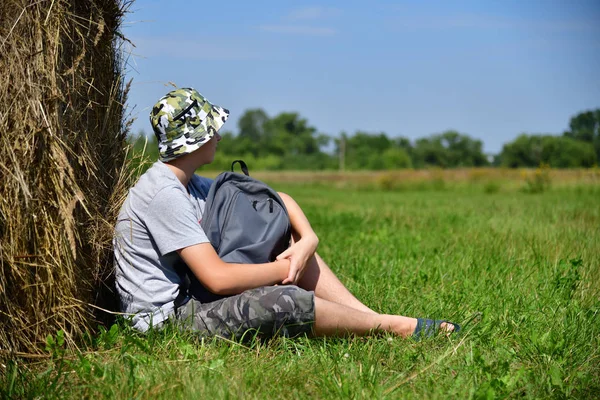 Nastolatek Plecakiem Siedzący Obok Stóg Słomy — Zdjęcie stockowe