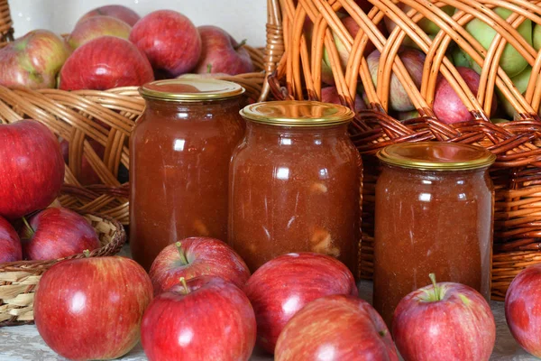 apple jam in glass jars and lots of a fresh apples