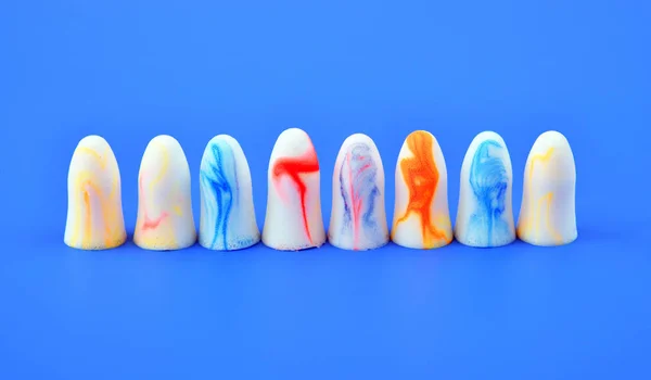 Multi Colored Earplugs Stand Row Blue Background — Stock Photo, Image